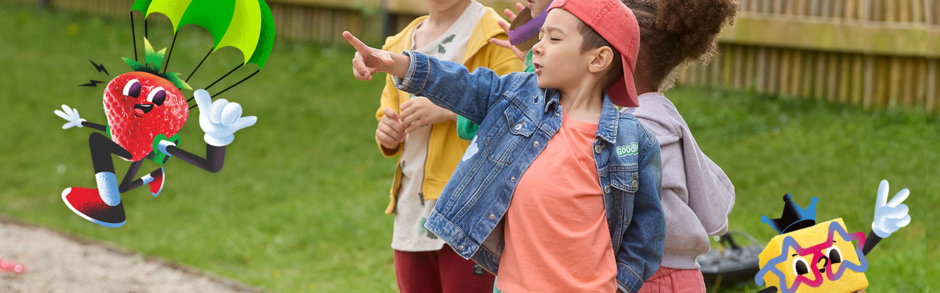 Boy pointing to a strawberry character